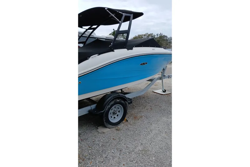 Slide: The Image of 2022 Sea Ray SPX 190 Outboard boat on trailer, featuring a sleek blue hull. - 2