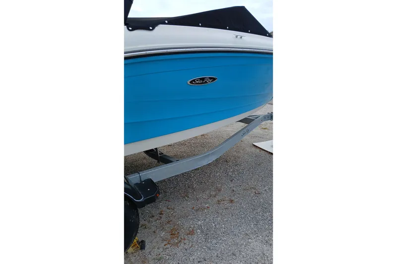 Slide: The Image of 2022 Sea Ray SPX 190 Outboard boat with blue hull on a trailer. - 4