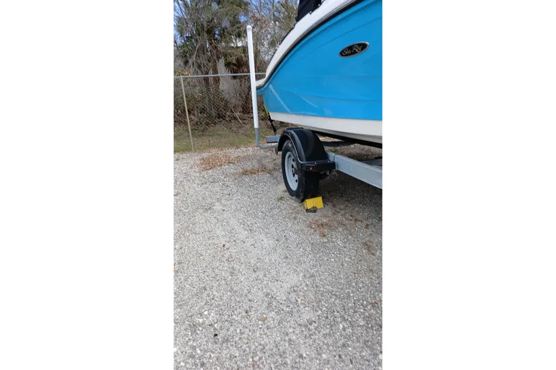 Slide: The Image of 2022 Sea Ray SPX 190 Outboard boat on trailer, parked on gravel. - 3