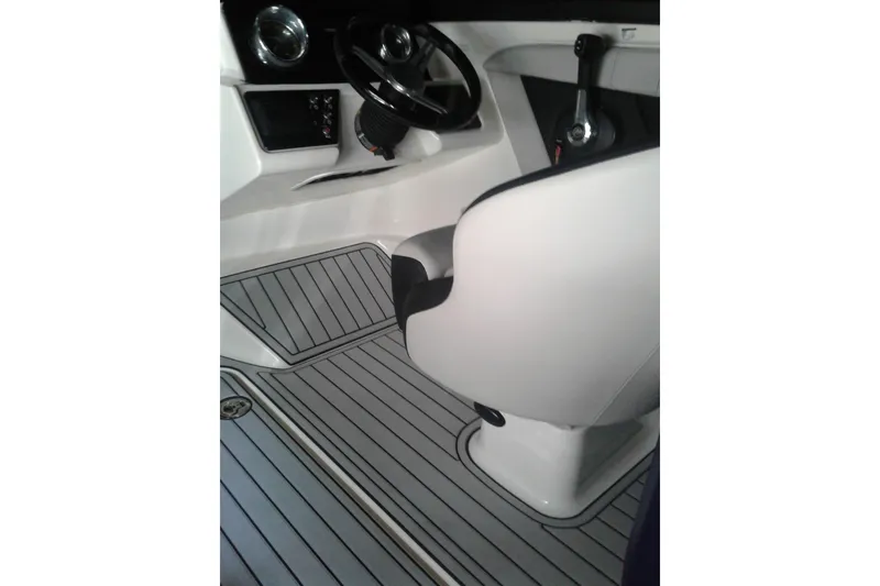 Slide: The Image of Interior of 2022 Sea Ray SPX 190 Outboard boat, featuring steering wheel and seating. - 7