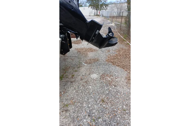 Slide: The Image of Outboard motor of 2022 Sea Ray SPX 190 on gravel path. - 9