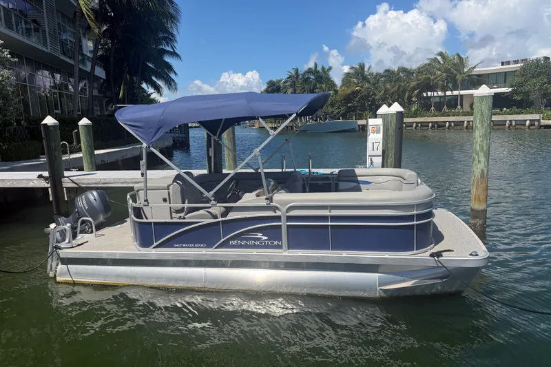The Image of 2023 Bennington 20 SVL pontoon boat docked on a sunny day. - 0