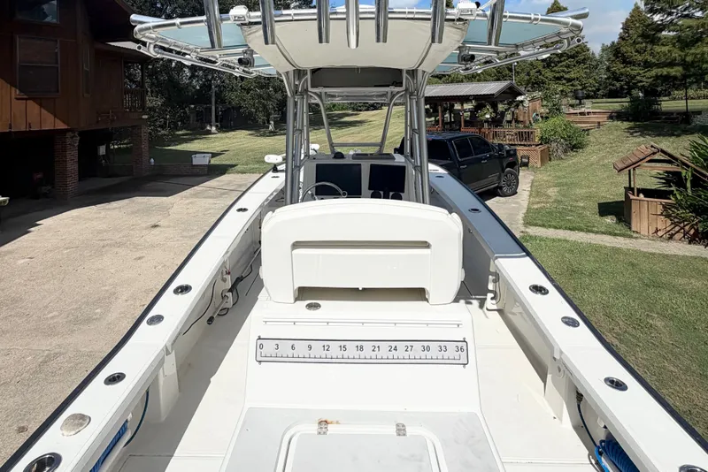 Slide: The Image of 2015 Calcutta 263 boat with center console, parked in a driveway near a house. - 13