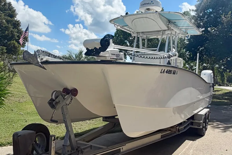 Slide: The Image of 2015 Calcutta 263 boat on trailer, clear sky, American flag in background. - 8