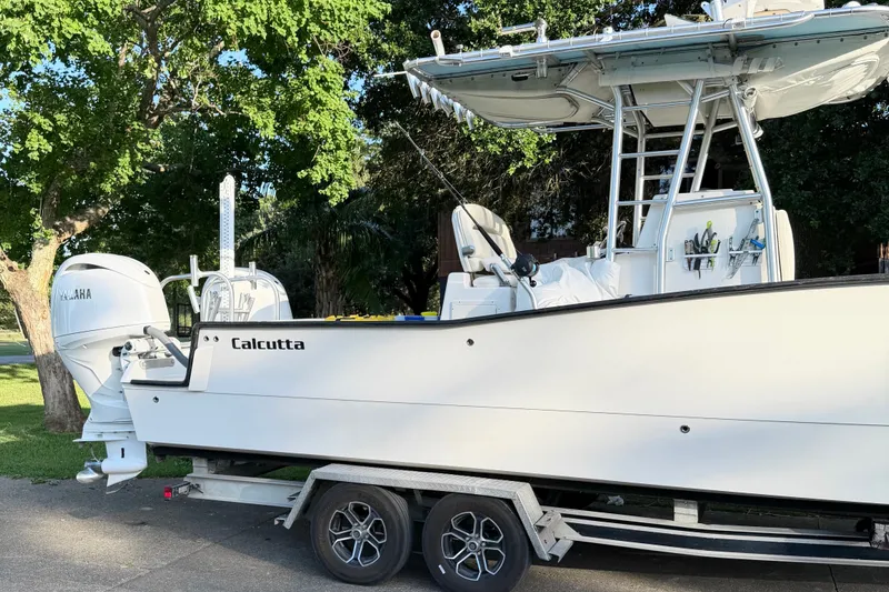 Slide: The Image of 2015 Calcutta 263 boat on trailer with Yamaha engine, parked outdoors. - 6
