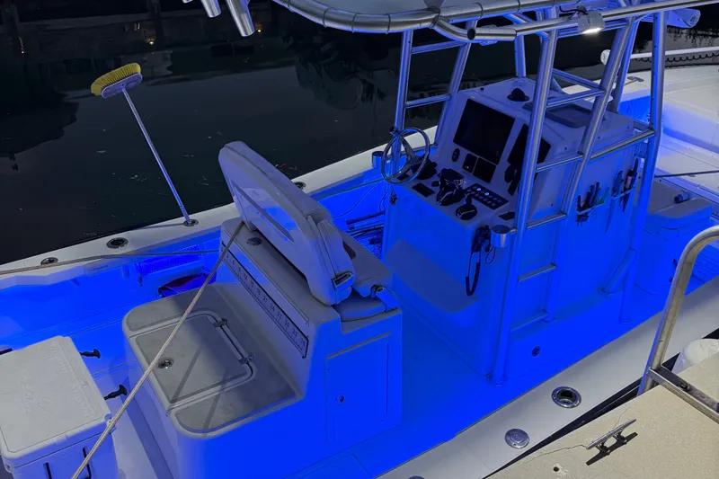 Slide: The Image of 2015 Calcutta 263 boat interior with blue LED lighting, featuring helm and seating area. - 10