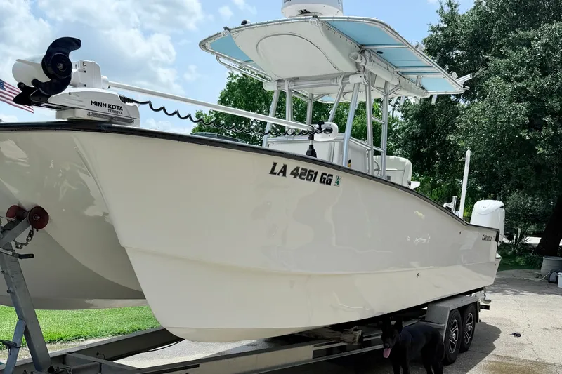 Slide: The Image of 2015 Calcutta 263 boat on trailer, featuring Minn Kota Terrova motor, parked outdoors. - 7