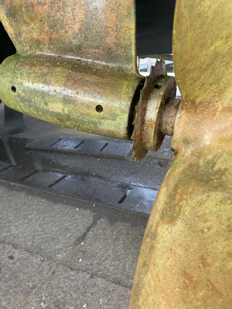 Slide: The Image of Close-up of a boat propeller showing visible wear and rust. - 14