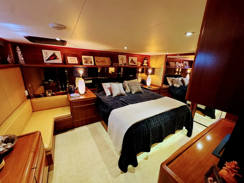 Slide: The Image of Luxurious yacht bedroom with a large bed, wooden furniture, and decorative pillows. - 41