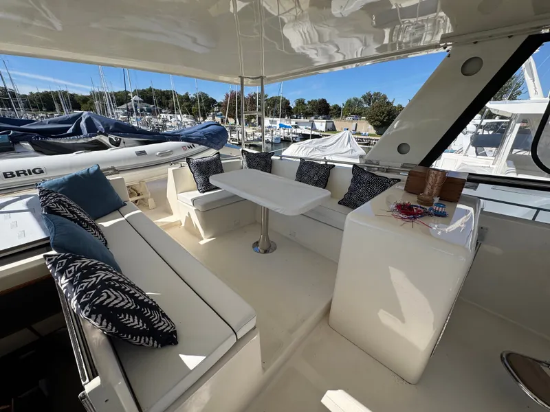 Slide: The Image of The image shows a yacht seating area with white cushions and blue pillows. - 17