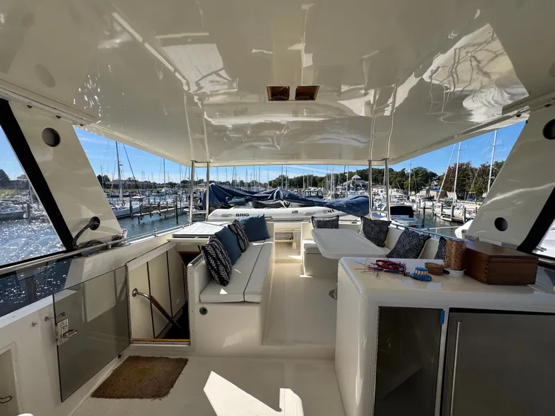 Slide: The Image of The image shows the spacious aft deck of a 1990 Viking 55 Motor Yacht Wide Body, featuring seating and a table. - 18
