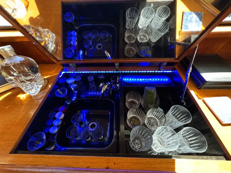 Slide: The Image of A stylish bar area with glasses and a decanter, illuminated by blue LED lights. - 34