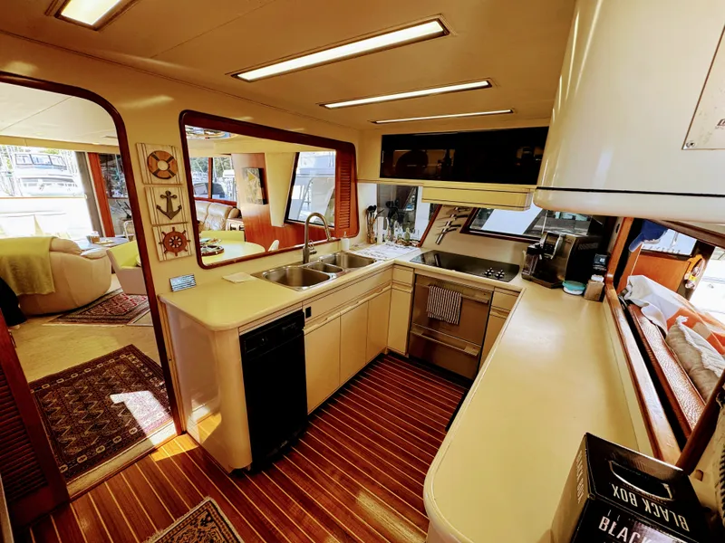 Slide: The Image of Interior of a 1990 Viking 55 Motor Yacht featuring a spacious kitchen and cozy living area. - 37