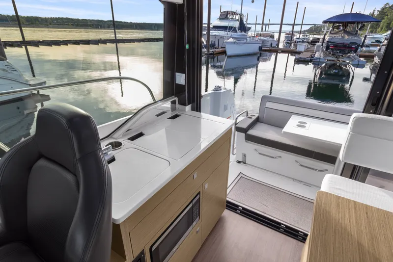 Slide: The Image of Interior view of 2025 Jeanneau NC 895 Series 2 yacht at marina, featuring sleek design. - 9