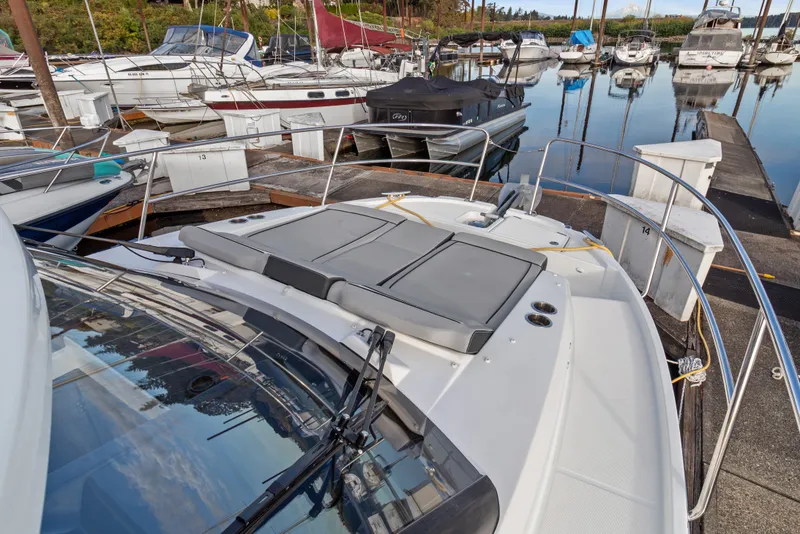 Slide: The Image of 2025 Jeanneau NC 895 Series 2 docked at marina, showcasing sleek design and spacious deck. - 29