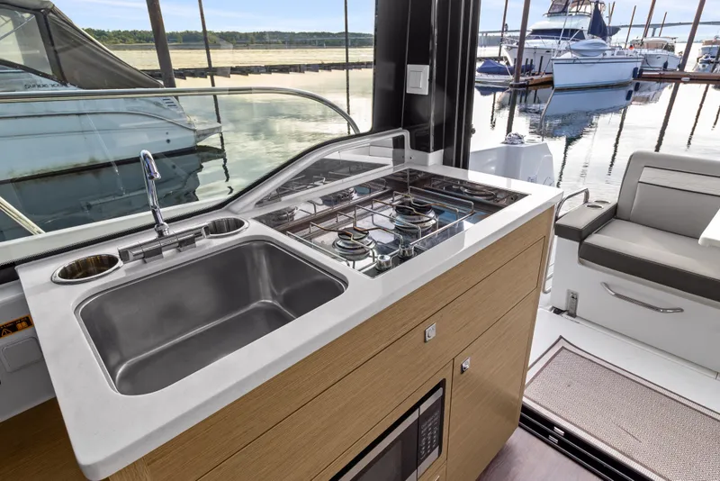 Slide: The Image of Modern kitchen area on 2025 Jeanneau NC 895 Series 2 yacht, featuring sink and stove. - 10
