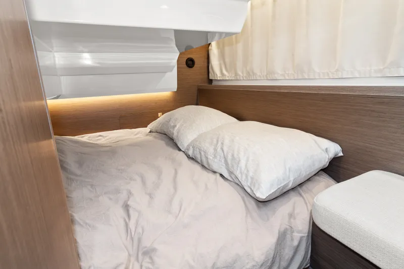 Slide: The Image of Cozy cabin interior of 2025 Jeanneau NC 895 Series 2 with comfortable bedding. - 18