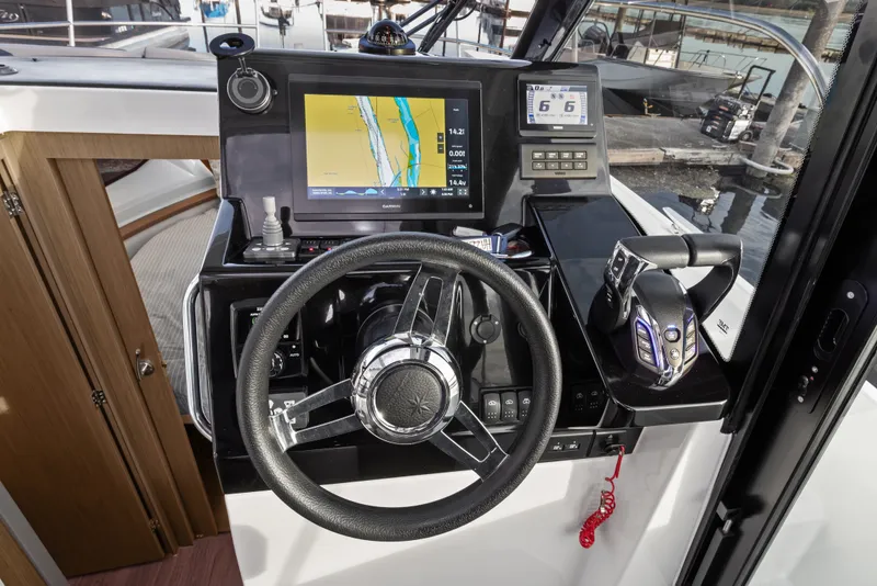 Slide: The Image of Helm of 2025 Jeanneau NC 895 Series 2 with navigation display and controls. - 12