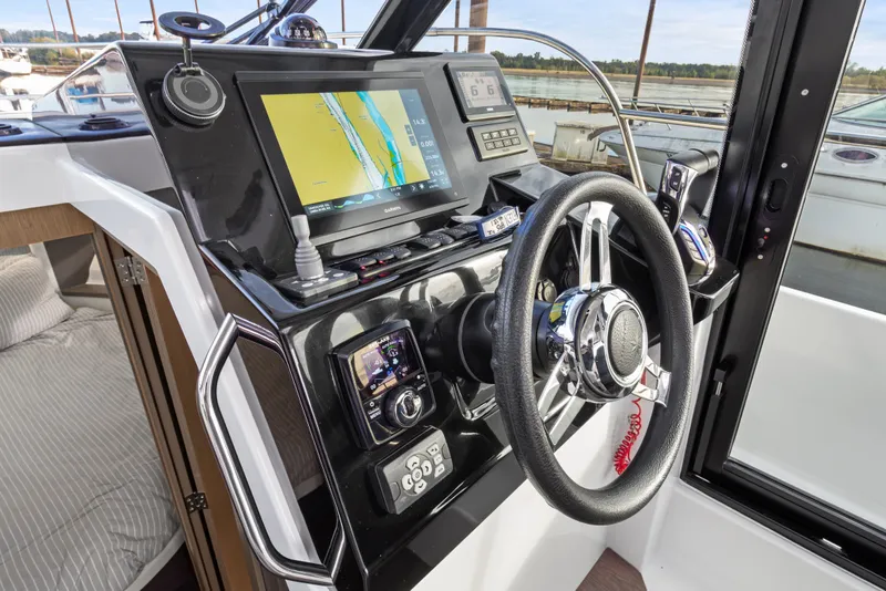 Slide: The Image of Helm of 2025 Jeanneau NC 895 Series 2 with navigation display and controls. - 13