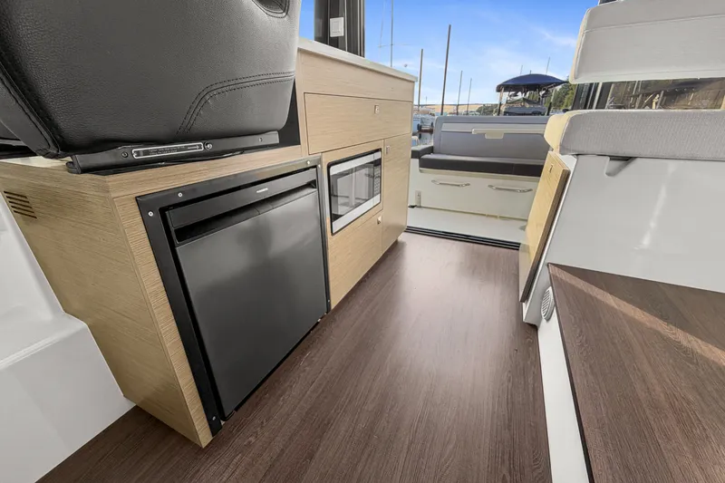 Slide: The Image of Interior of 2025 Jeanneau NC 895 Series 2 boat with modern kitchen amenities. - 11