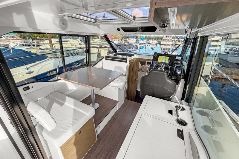 Slide: The Image of Interior of 2025 Jeanneau NC 895 Series 2 boat, featuring modern seating and navigation area. - 3