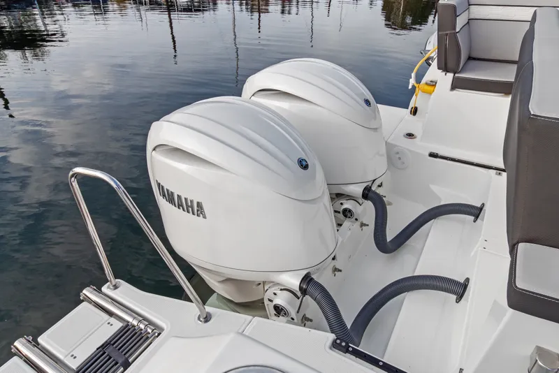 Slide: The Image of 2025 Jeanneau NC 895 Series 2 with dual Yamaha outboard engines on calm water. - 27