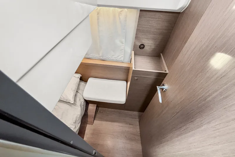 Slide: The Image of 2025 Jeanneau NC 895 Series 2 cabin interior with modern wood finish and compact design. - 19