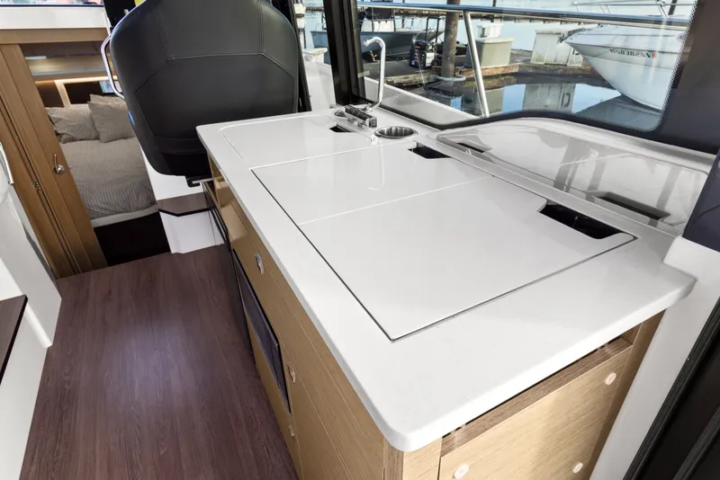 Slide: The Image of Modern kitchen area in 2025 Jeanneau NC 895 Series 2 boat, featuring sleek countertops and cabinetry. - 8