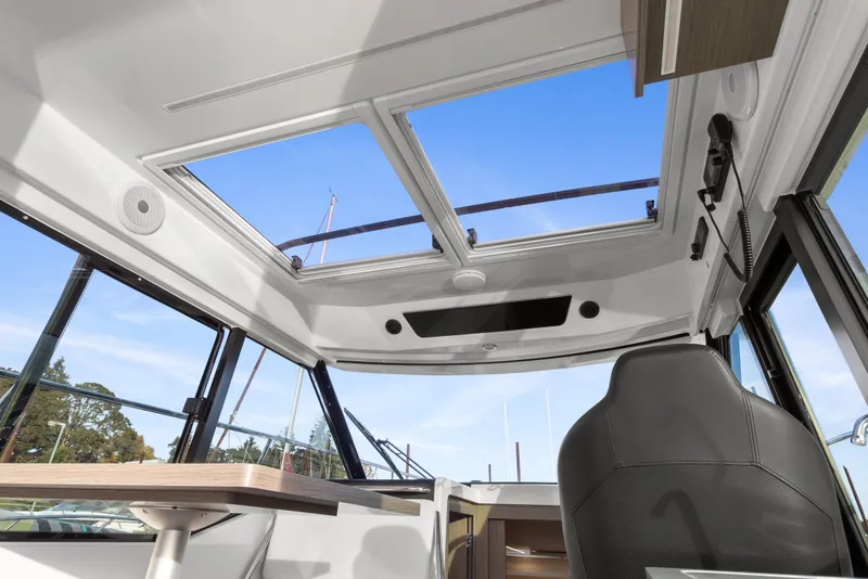 Slide: The Image of Interior view of 2025 Jeanneau NC 895 Series 2 boat with skylight and seating. - 7
