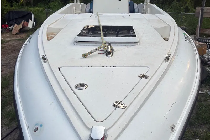 Slide: The Image of 1990 Custom Center Console Signature boat with white deck and rope, docked outdoors. - 3