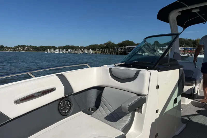 Slide: The Image of 2021 Chaparral 307 SSX boat interior with seating, on a sunny day by the water. - 34