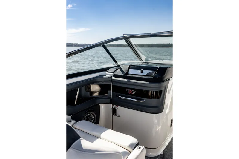 Slide: The Image of 2021 Chaparral 307 SSX boat interior with sleek dashboard and comfortable seating. - 25