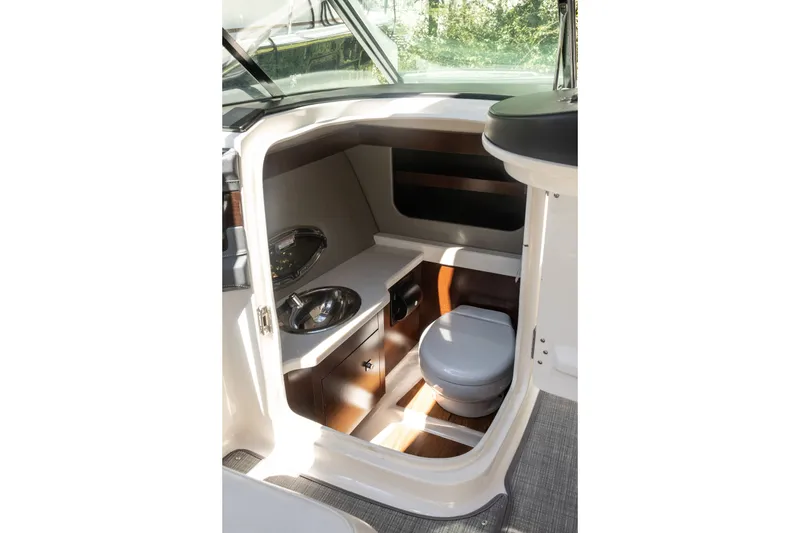 Slide: The Image of 2021 Chaparral 307 SSX boat interior with compact bathroom and sink. - 26