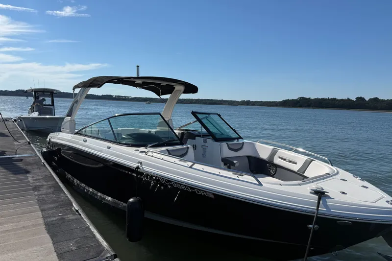 Slide: The Image of 2021 Chaparral 307 SSX boat docked on a sunny day by the water. - 37