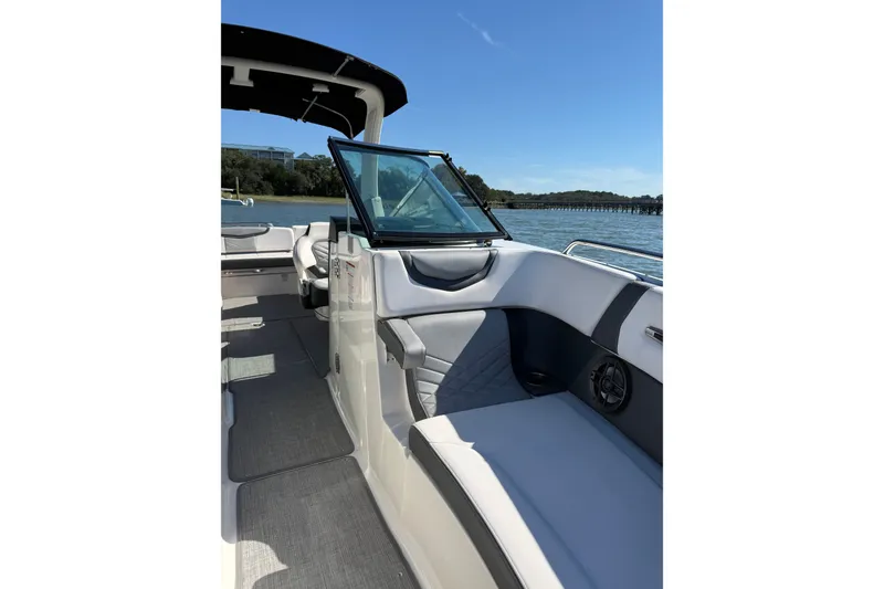 Slide: The Image of 2021 Chaparral 307 SSX boat interior with seating, on a sunny day by the water. - 33