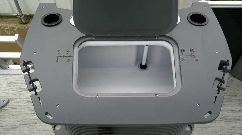 Slide: The Image of An open storage compartment on a Bennington 22 SFC boat, with measurement markings on the side. - 18