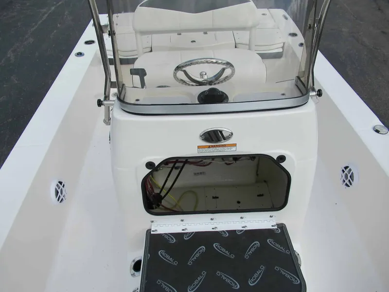 Slide: The Image of The image shows the cockpit of a Robalo 206 Pro boat with an open storage compartment. - 9