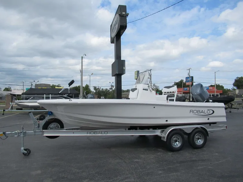 Slide: The Image of A white 2027 Robalo 206 Pro boat sits on a trailer in a parking lot. - 12