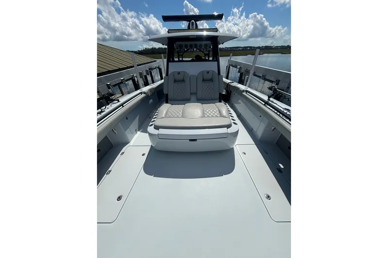 Slide: The Image of 2023 Barker Boatworks 40 HPC interior with luxurious seating and spacious deck. - 12