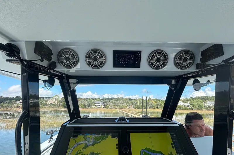 Slide: The Image of 2023 Barker Boatworks 40 HPC helm with navigation display and audio system. - 3