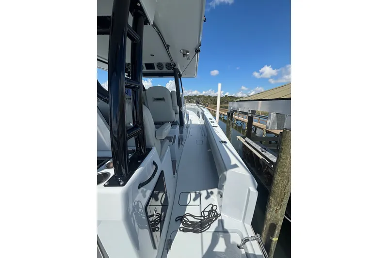 Slide: The Image of 2023 Barker Boatworks 40 HPC, sleek deck view, docked under clear blue sky. - 22