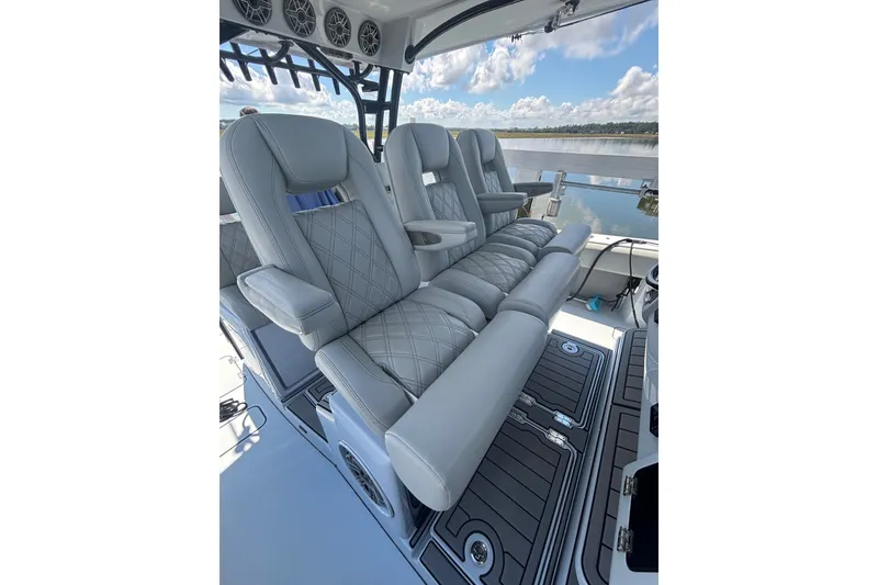 Slide: The Image of Luxurious seating on 2023 Barker Boatworks 40 HPC, featuring elegant gray upholstery and armrests. - 4