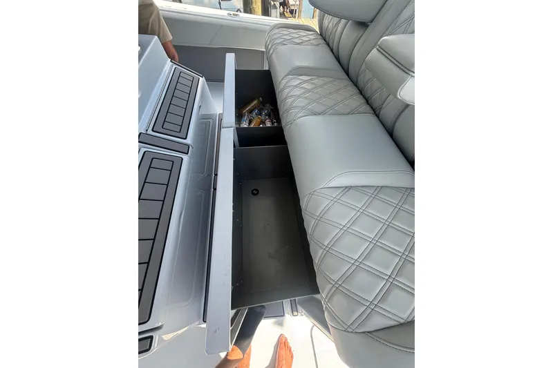 Slide: The Image of 2023 Barker Boatworks 40 HPC interior with open storage compartment and quilted seating. - 7
