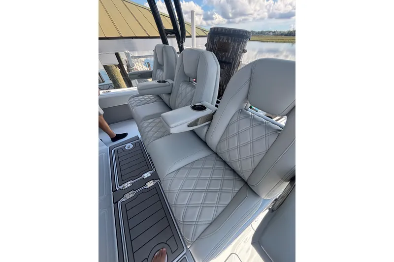 Slide: The Image of Luxurious seating on 2023 Barker Boatworks 40 HPC, featuring diamond-stitched upholstery and cup holders. - 5