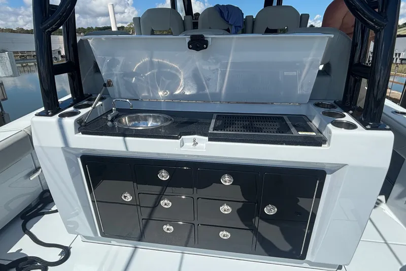 Slide: The Image of 2023 Barker Boatworks 40 HPC boat interior with sink, grill, and storage drawers. - 24