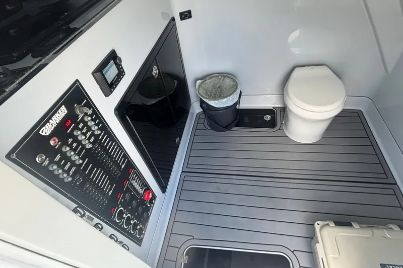 Slide: The Image of Interior of 2023 Barker Boatworks 40 HPC featuring control panel and marine toilet. - 9