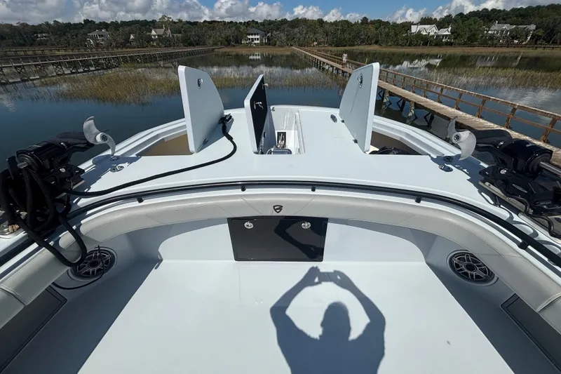 Slide: The Image of 2023 Barker Boatworks 40 HPC on calm water, showcasing spacious deck and storage compartments. - 16
