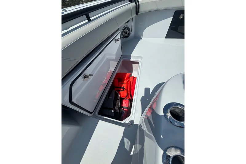 Slide: The Image of Storage compartment on 2023 Barker Boatworks 40 HPC, featuring life jackets and safety gear. - 18