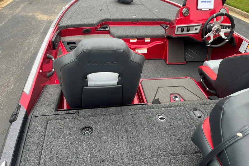 Slide: The Image of 2027 Nitro Z19 XL boat interior with red accents and steering console. - 3