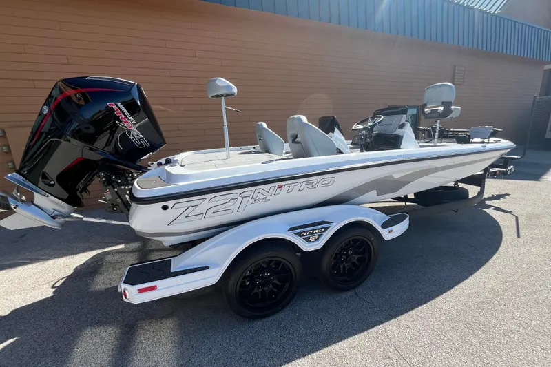 Slide: The Image of 2027 Nitro Z21 XL Pro boat with trailer, parked outdoors, featuring sleek design and powerful engine. - 6